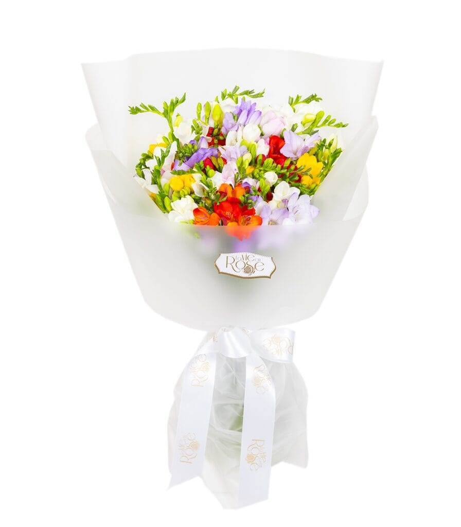 Colourful freesias with bouquet wrapping and ribbon
