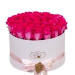 47 pink roses arranged in a round box