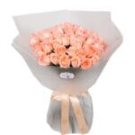 Peach rose bouquet with wrapping and ribbon