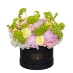 Diaphanous mixed flower arrangement in a box