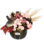 Boho-style flower arrangement in a pumpkin