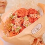 Pretty in Autumn bouquet with leucospermum and mixed roses