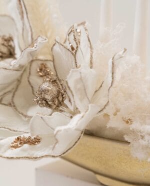 Golden Drift magnolia-style arrangement with pearls on a gold tray