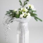 Whispering Pines white rose and amaryllis bouquet with frosted pine