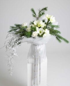 Whispering Pines white rose and amaryllis bouquet with frosted pine