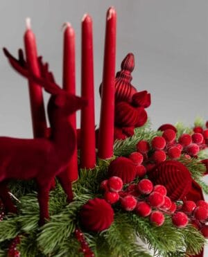 Majestic Red Candle Centerpiece with pine, decorative candles and reindeer figures