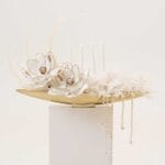 Golden Drift magnolia-style arrangement with pearls on a gold tray