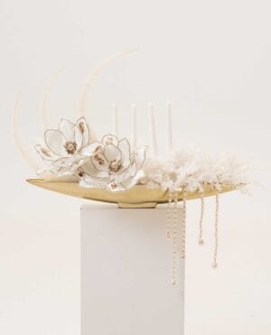 Golden Drift magnolia-style arrangement with pearls on a gold tray