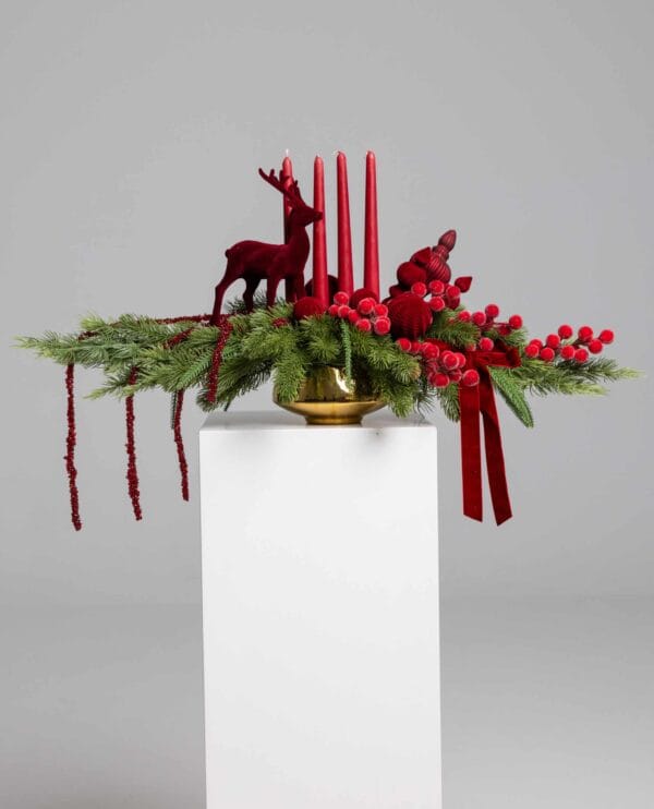 Majestic Red Candle Centerpiece with pine, decorative candles and reindeer figures