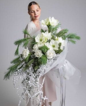 Whispering Pines white rose and amaryllis bouquet with frosted pine