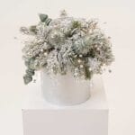 Crystal Round Arrangement with frosted pine and pearl accents in a ceramic vase
