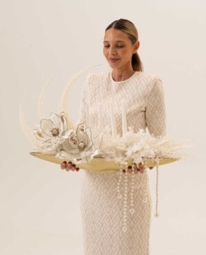 Golden Drift magnolia-style arrangement with pearls on a gold tray